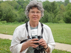 Photo of Barb Duerksen holding binoculars