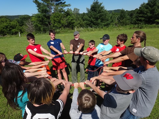 Campers in a circle engaged in team building